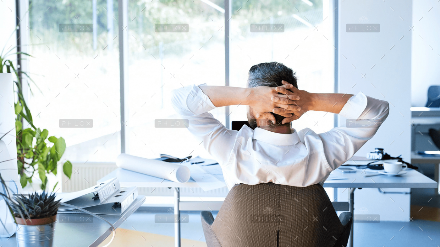 demo-attachment-477-Businessman-at-the-desk-in-his-office-resting.